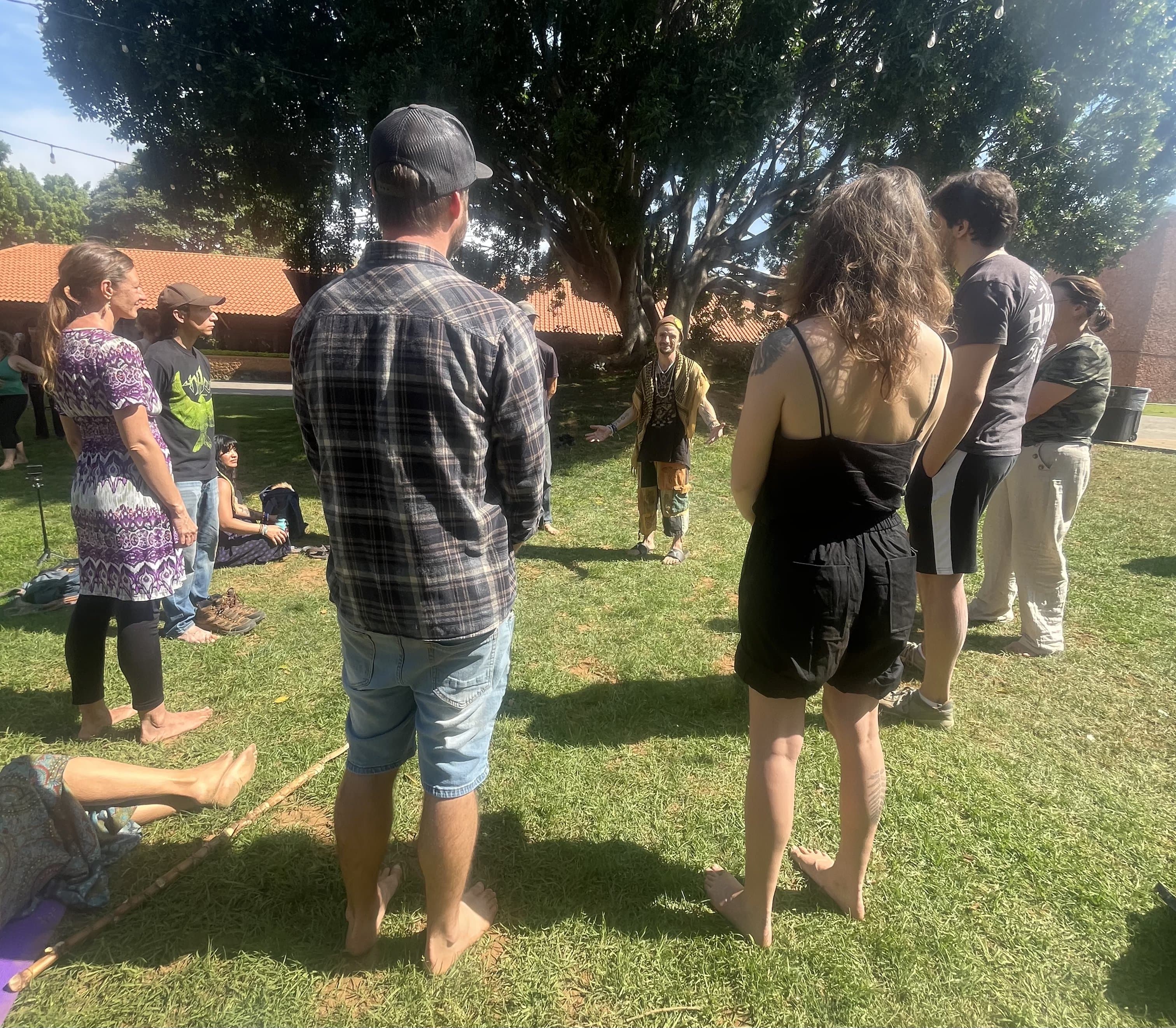 Participants engaged in a standing group activity outdoors
